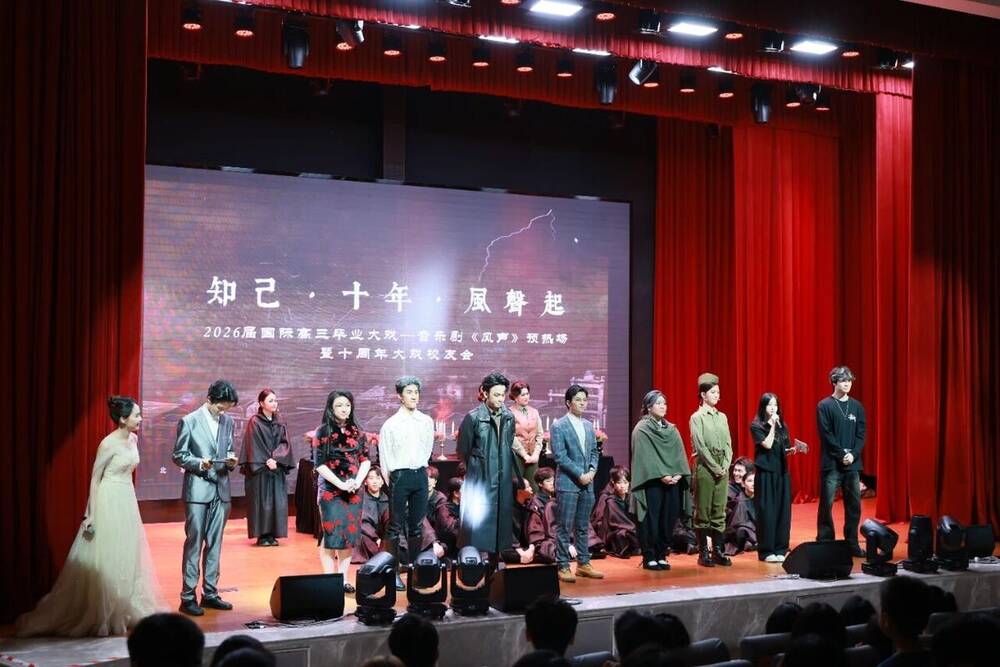 Alumni in costume on stage during the tenth-anniversary reunion