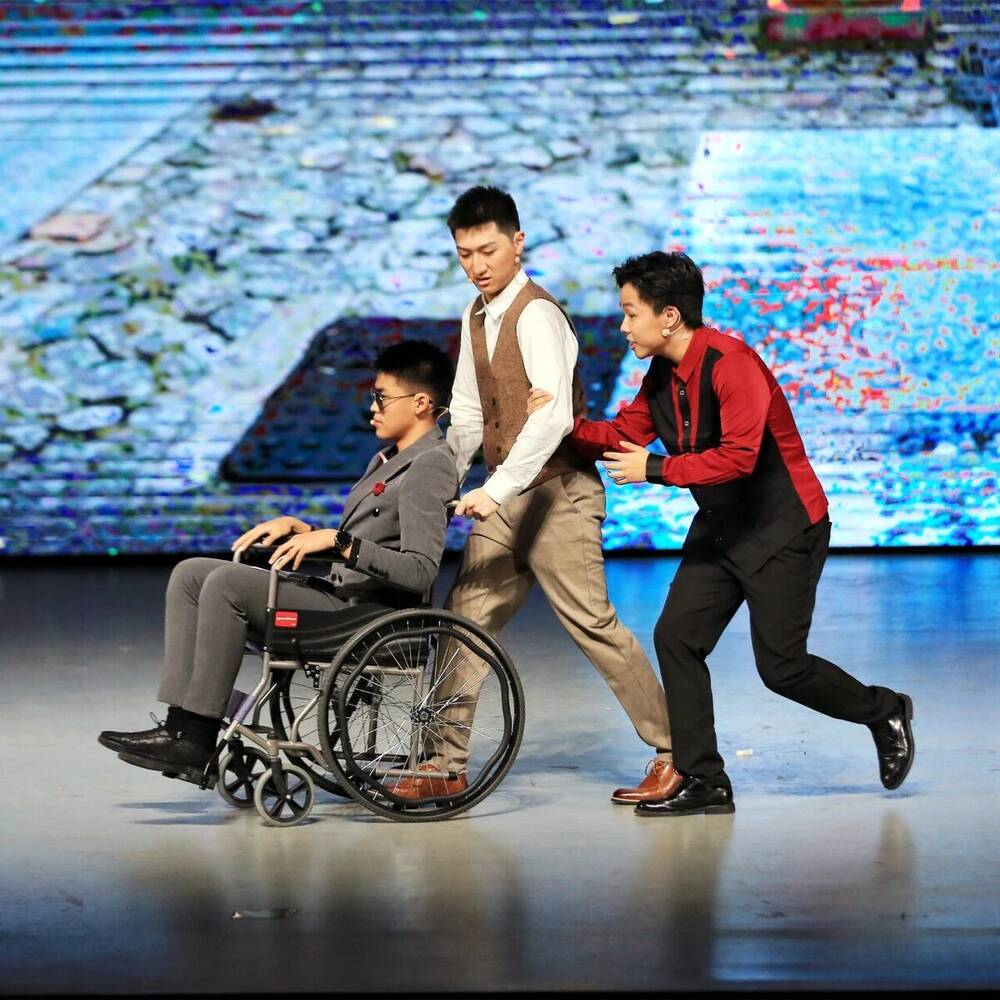 A wheelchair chase across the stage during a comic scene