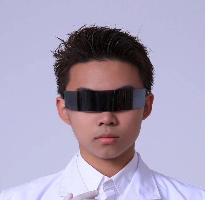 A student in a white coat wearing a dark visor, in character for the play 2021