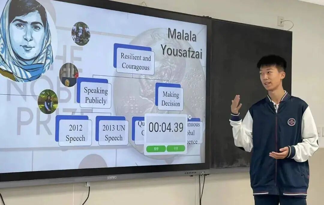 A student presenting a project on Malala Yousafzai on a classroom screen