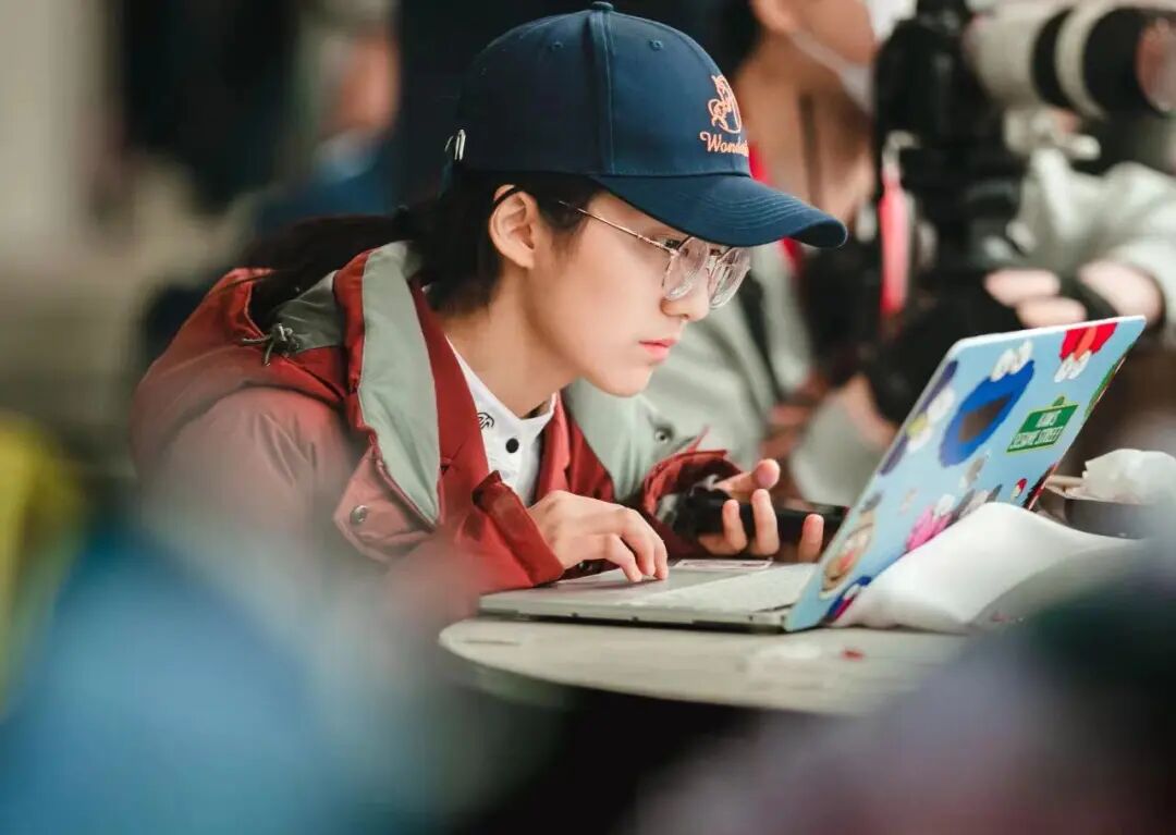 A student working on a laptop between training sessions